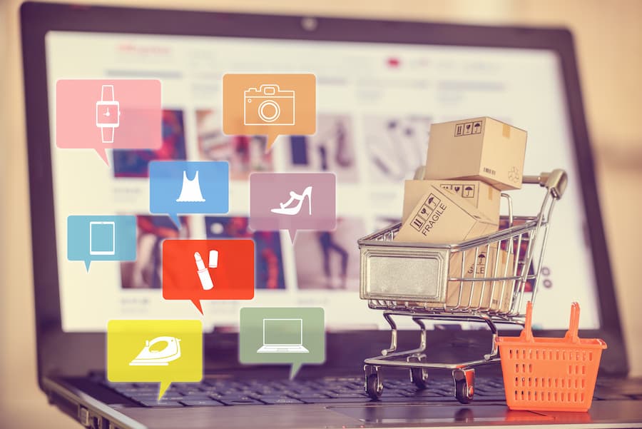 Social media for marketing and online shopping concept with laptop and cart